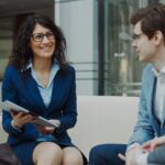 Professionals discussing business strategy in a corporate office setting.