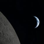 Crescent earth seen from the moon's surface